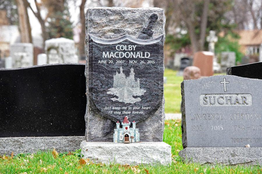A very special custom sculptured memorial in Bahama Blue granite on a Galaxy Grey base. Customized with a Diamond Impact etching. 