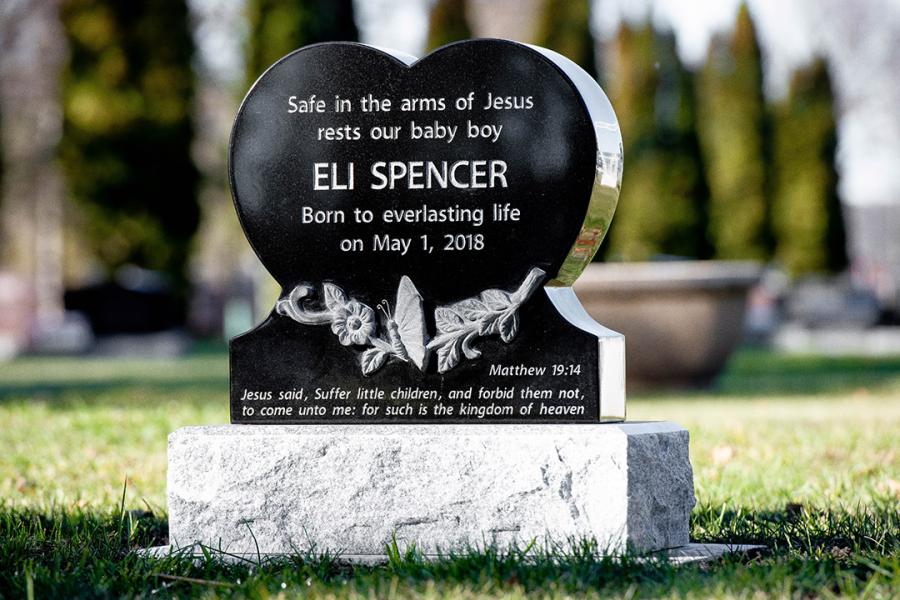 Spencer, this small all-polished custom heart design features sculptured hands and flowers. Set atop a standard Galaxy Grey granite base to add contrast to the lettering. 