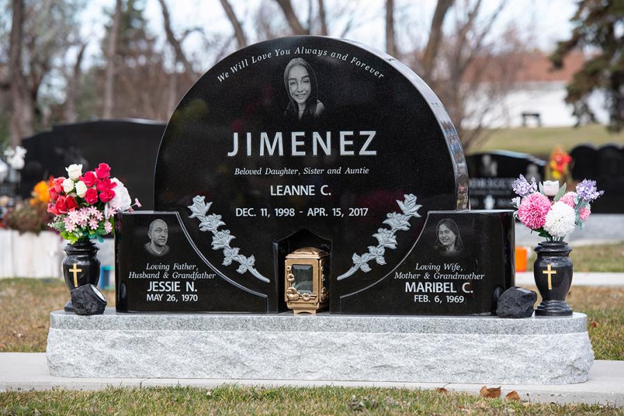 Midnight black Custom Design memorial on a Galaxy Grey base with matching granite vases located in Assumption Cemetery. Featured add-ons, a bronze lantern and Diamond Impact etching portraits