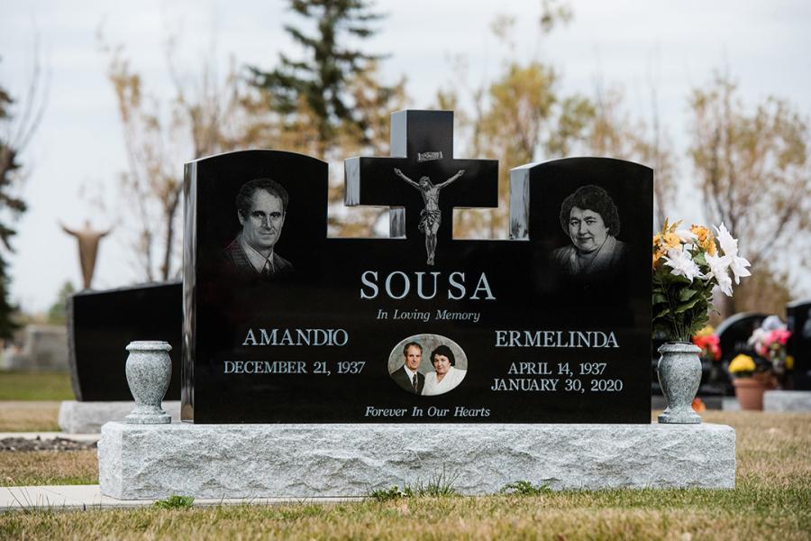 Sousa is a custom design Midnight Black Wing-style memorial installed in Assumption cemetery. Featured add-ons, Diamond Impact Etched portraits & religious motifs, one stainless steel b/w picture with two Galaxy Grey granite vases on a standard Galaxy Grey granite base. 
