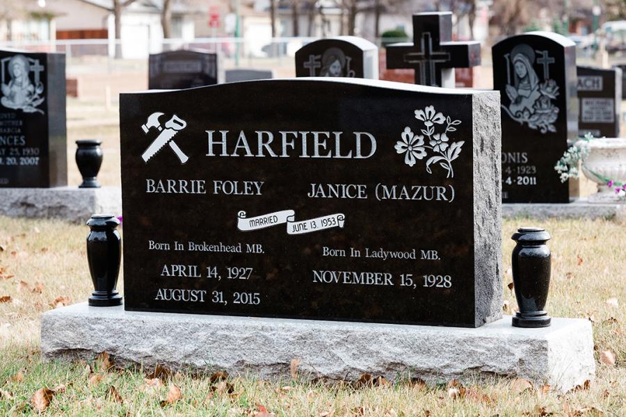 Harfield, a traditional style double memorial in Midnight black on a standard Galaxy Grey base. Customizations, a polish top and two matching Midnight Black granite vases.