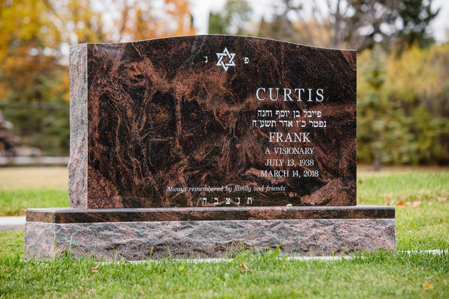 Curtis, a traditional sized 48 x 8 x 28 Aurora granite memorial on a matching base. Customizations: a 2" margin base