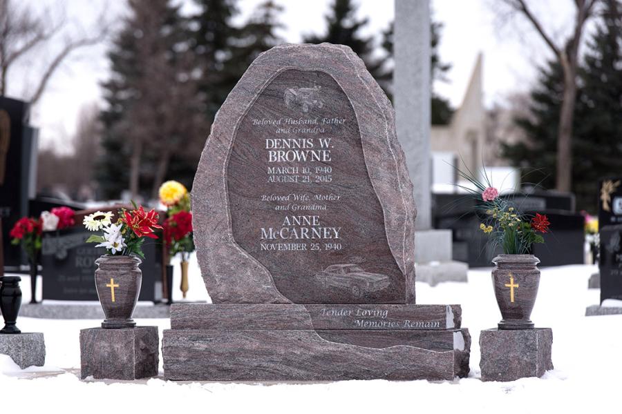 Boulder Style Custom Design Memorial in Paradiso Granite. Featured add-ons, Diamond Impact Etched images, gold paint detailing, and two matching granite vases on a custom design matching granite base