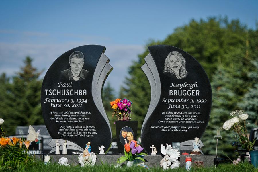 A custom design Midnight Black wing style memorial for two young teens. Customized with Diamond impact Etched Portraits and vase