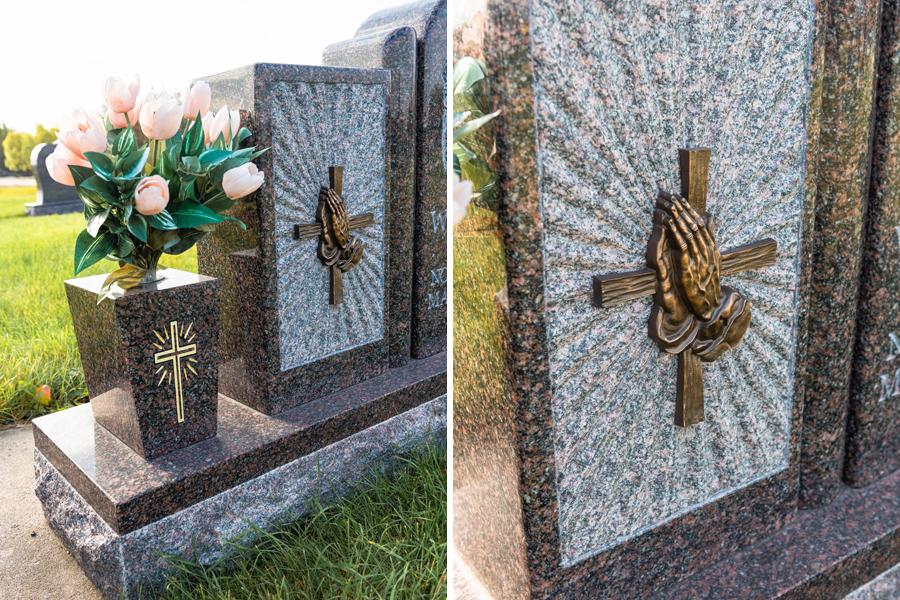 Accessories adorning this beautiful custom memorial is matching Granite vases, adorned with gold paint detailing and a Bronze cross & praying hands emblem. Located in the Holy Family Cemetery