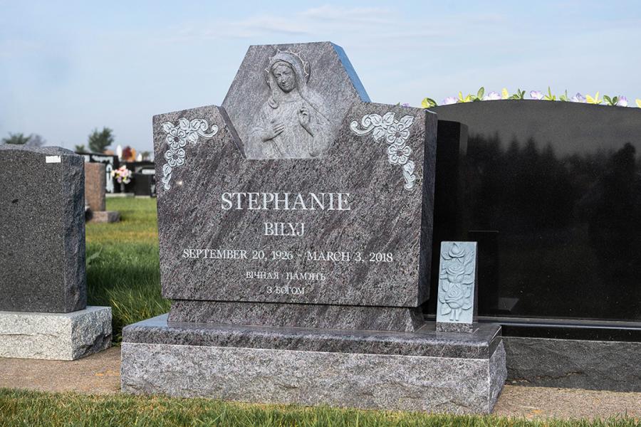 Bahama Blue Custom Sculptured Memorial on a Matching 2" polish top margin base with a matching flowerless vase located in Holy Family Cemetery