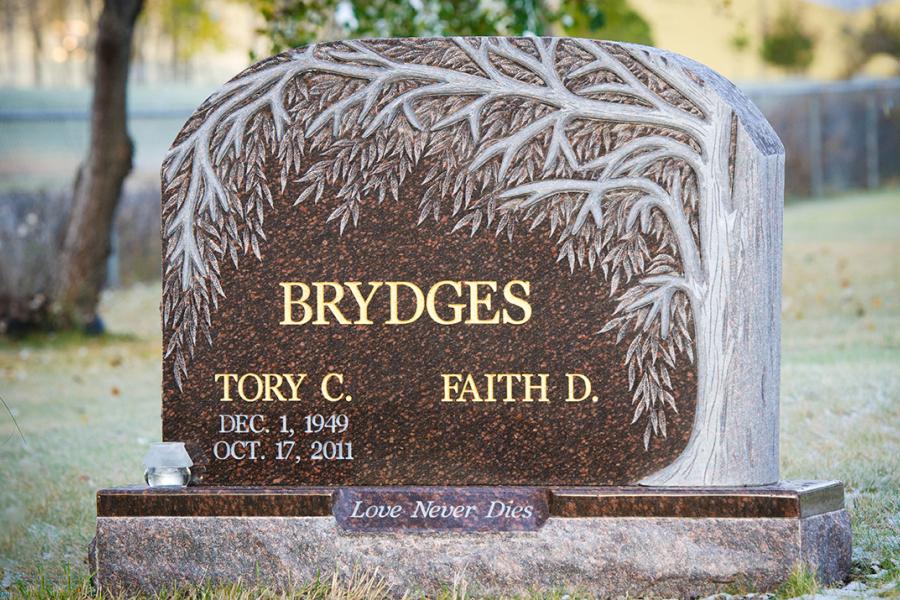 Brydges, Custom Design Cats Eye Brown Granite Willow Tree memorial. Featured add-ons, Gold paint lettering on a matching polish top (with panel) 2" margin granite base. Located in Lake of the Woods Cemetery, Kenora