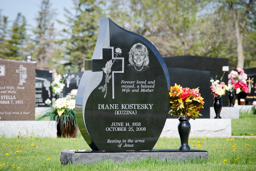 Custom Teardrop Style Memorial. Featured add-ons, Diamond Impact Etched Portrait with one matching granite vase atop a matching Midnight Black base