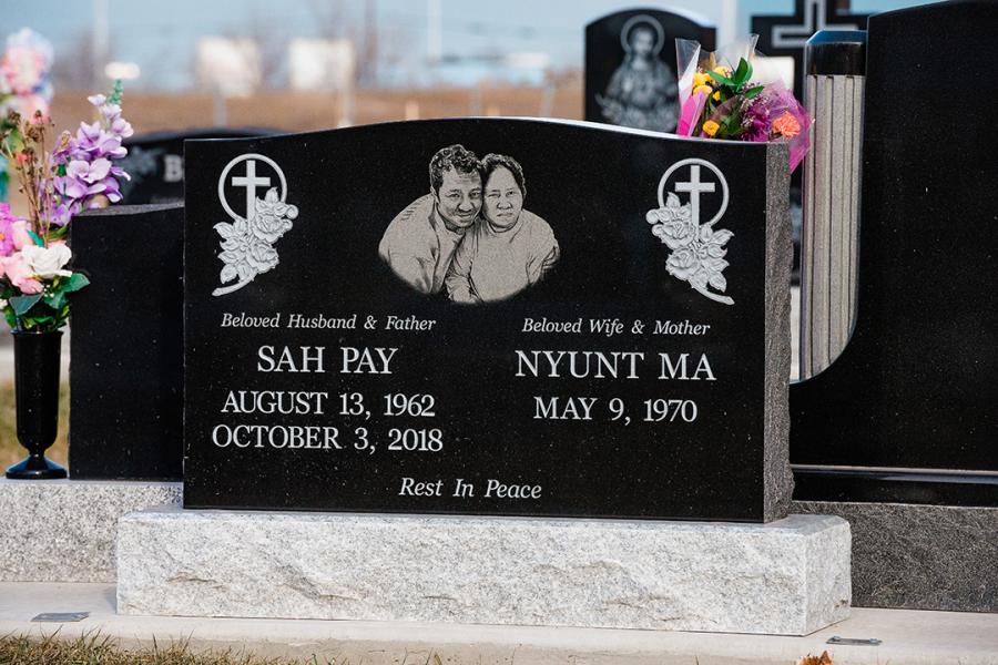 Sah Pay, Midnight Black traditional style memorial on a Standard Galaxy Grey base. While the Galaxy grey base is the neutral or standard base option, it pairs very well with multiple granite colour choices. Customers often like that the light base matches the lettering and adds contrast to the darkness of the granite on the memorial,  making it a prominent selection by many. Customized with a Diamond Impact Etched double portrait, this memorial can be found in the newer section of Brookside cemetery. 