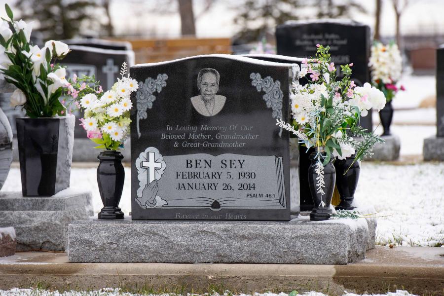 Sey, This classic Midnight Black style single memorial and a Galaxy grey granite base. Customizations to this memorial are two granite vases and a Diamond Impact Etched portrait located in Brookside cemetery.