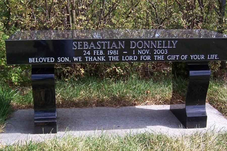 Donnelly, Midnight Black classic memorial granite bench installed in Assumption Catholic cemetery
