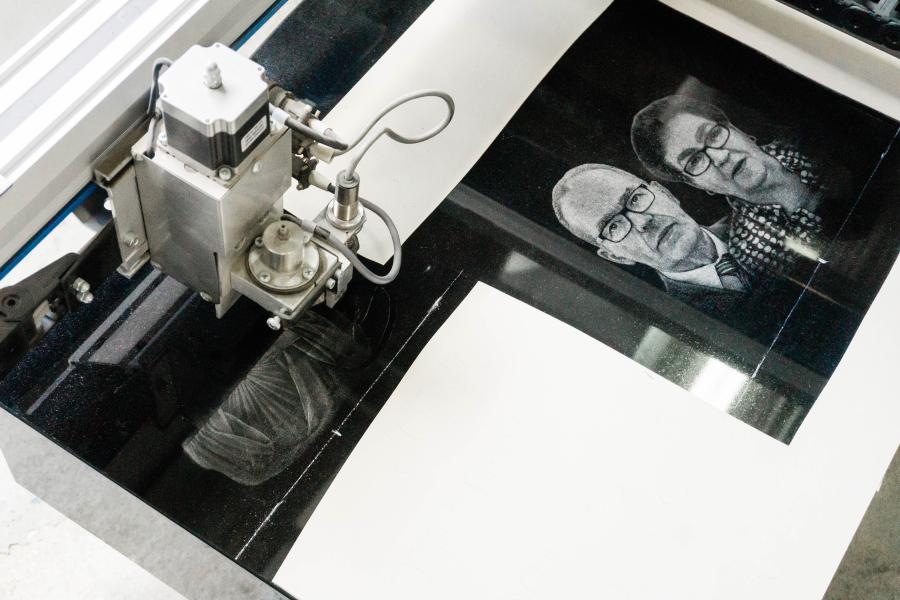 Our Diamond Impact Etching Machine completing a custom double portrait on a Midnight Black monument. Customers often opt for a Diamond Impact Etched portrait for several reasons; they are beautiful, natural and maintenance free options over steel, porcelain or plastic pictures which can fade over time. Unlike a laser etching machine that can only etch onto black granite, our Diamond Impact Etcher can etch onto multiple granite colour surfaces to create a memorial as unique as your loved one. 
